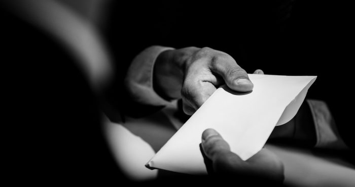 Businessman,Giving,Bribe,Money,In,The,Envelope,To,Partner,In